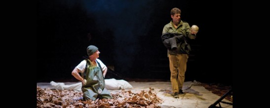 Production shot of Hamlet, the Gravedigger and poor Yorick.
